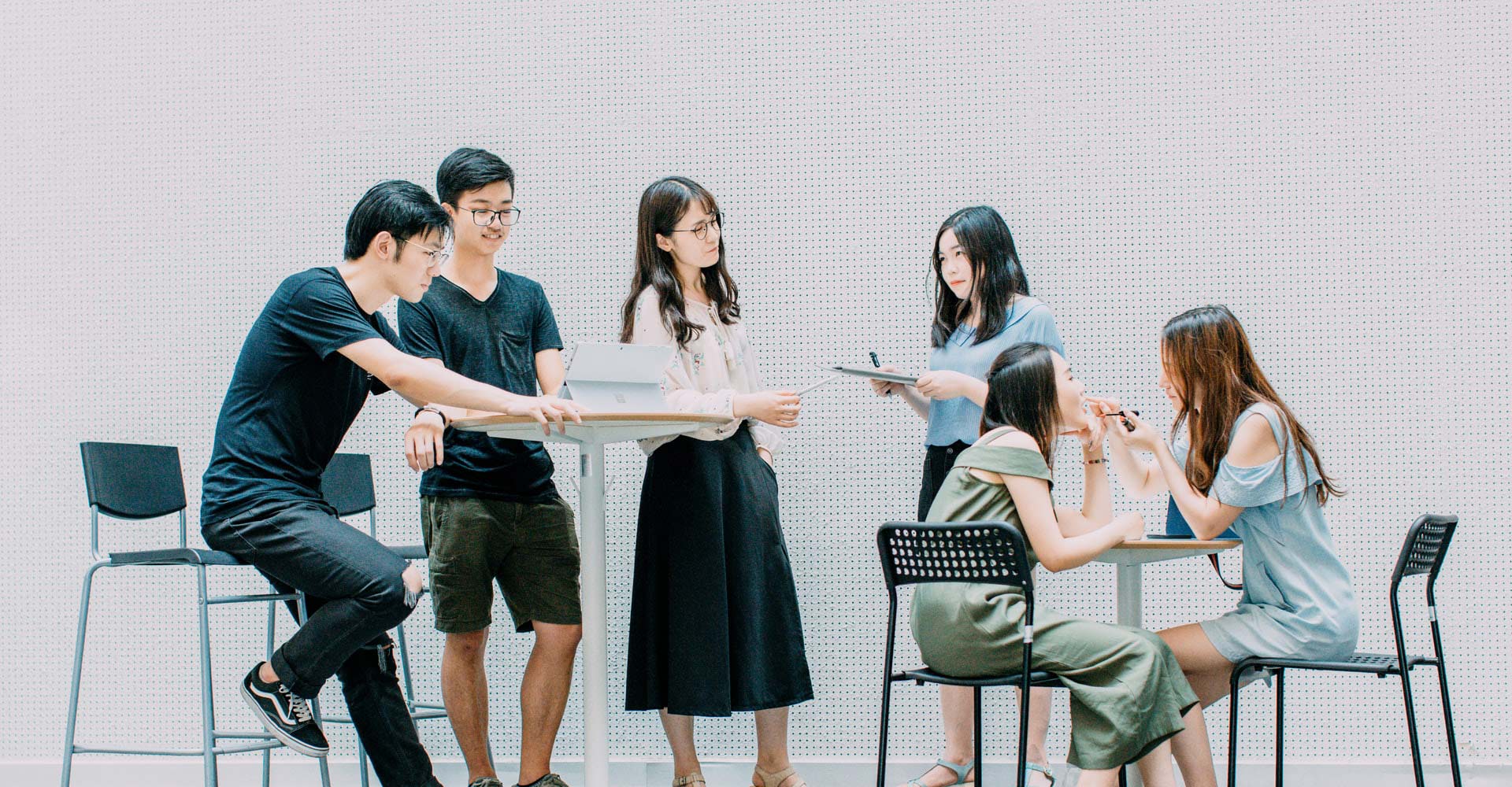 Young workers sitting at tables